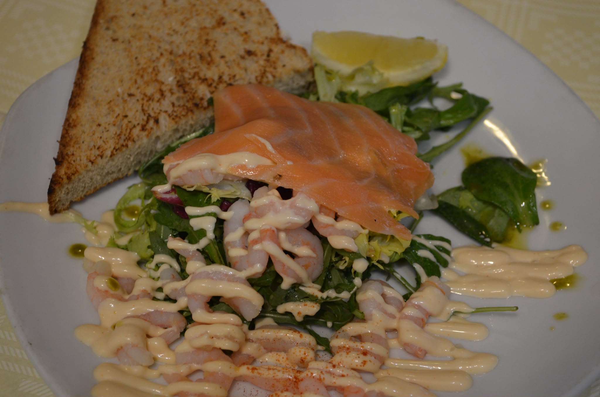 Smoked salmon draped over a prawn and rocket salad with marie rose sauce