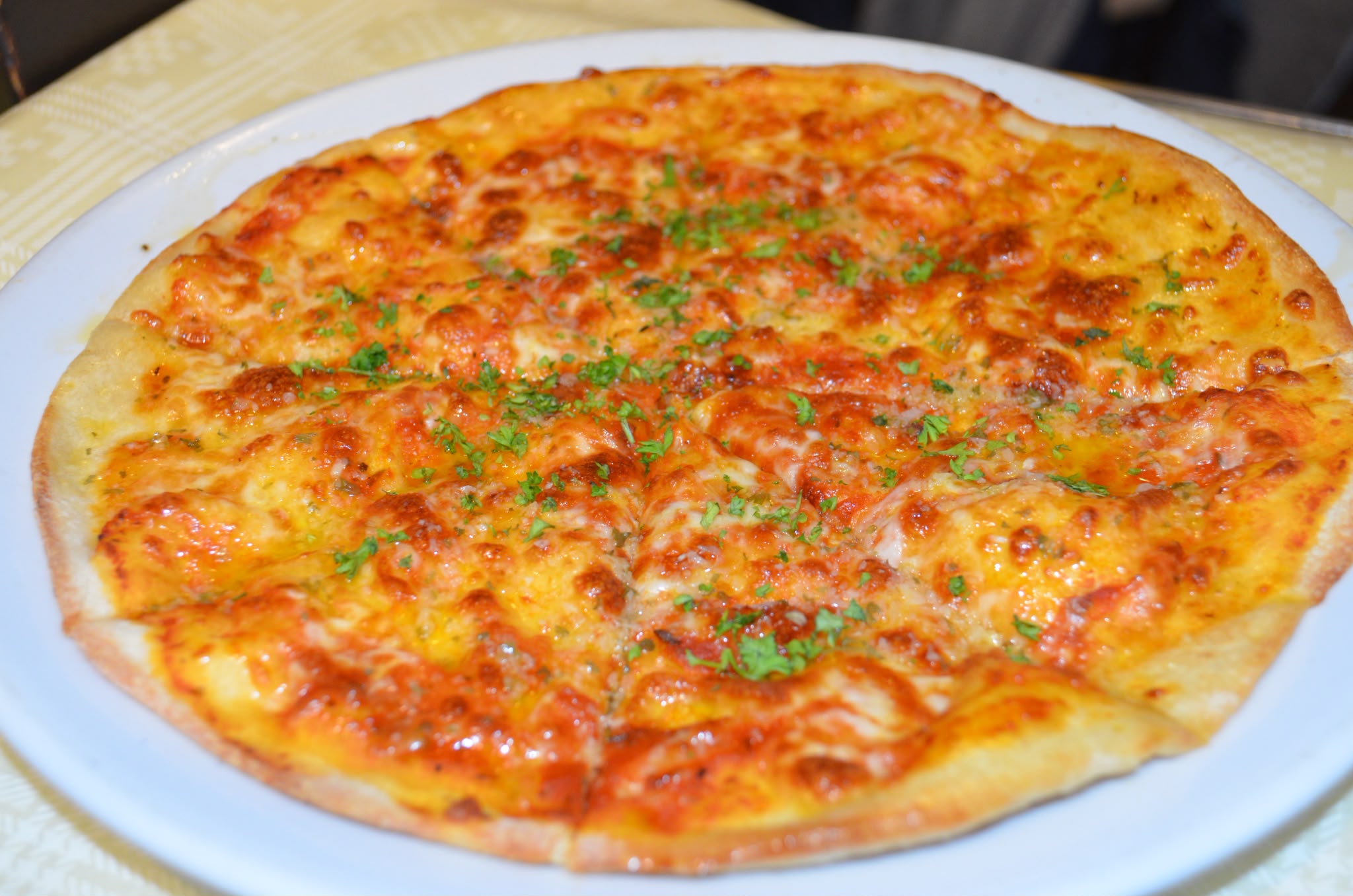 Thin and crispy cheese and tomato pizza with a golden baked crust
