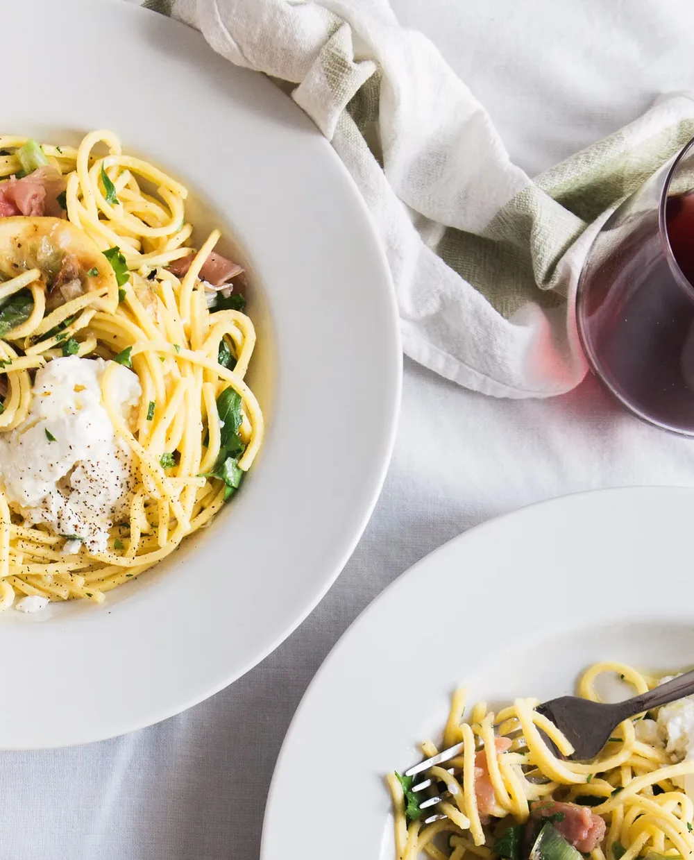Bowls of freshly made spaghetti served with a glass of red wine at Piccolos Restaurant