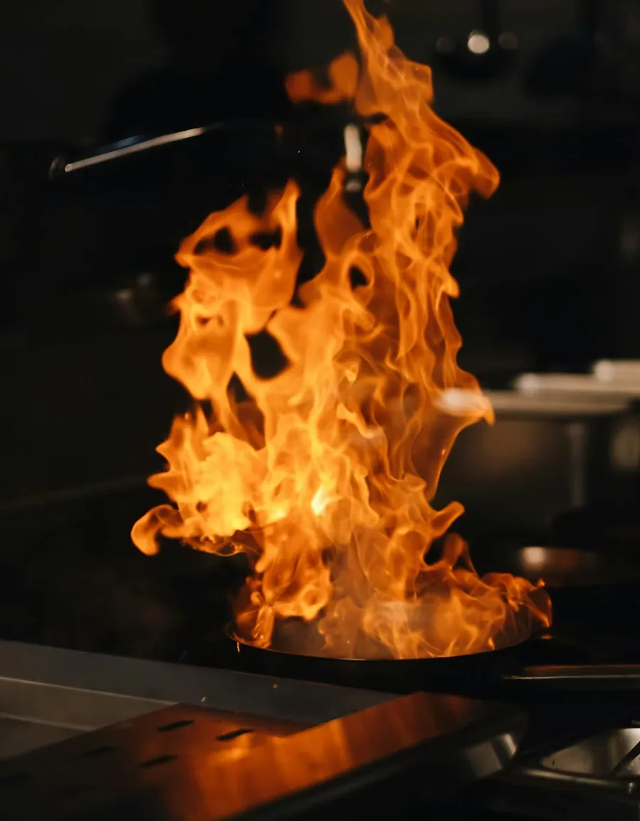 Flames rising from a pan in the Piccolos kitchen