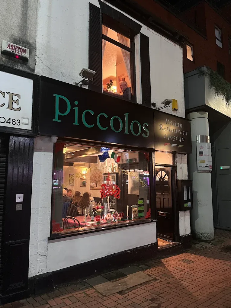 Piccolos Italian Restaurant frontage on Convent Walk, Sheffield, lit up at night